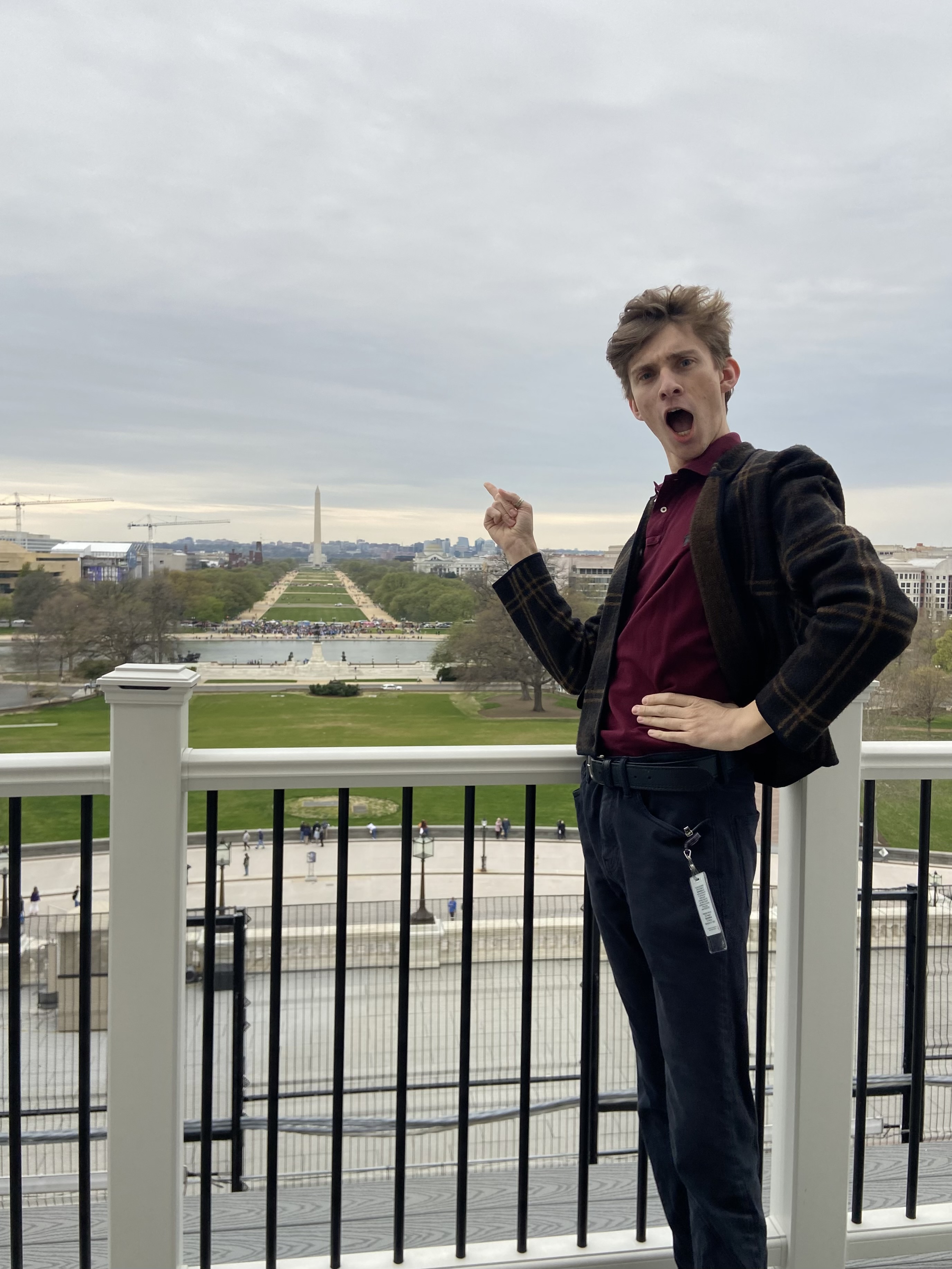 Spring 2023 UCDC Fellow Alejandro Alvarez standing with the Washington Monument in the distance