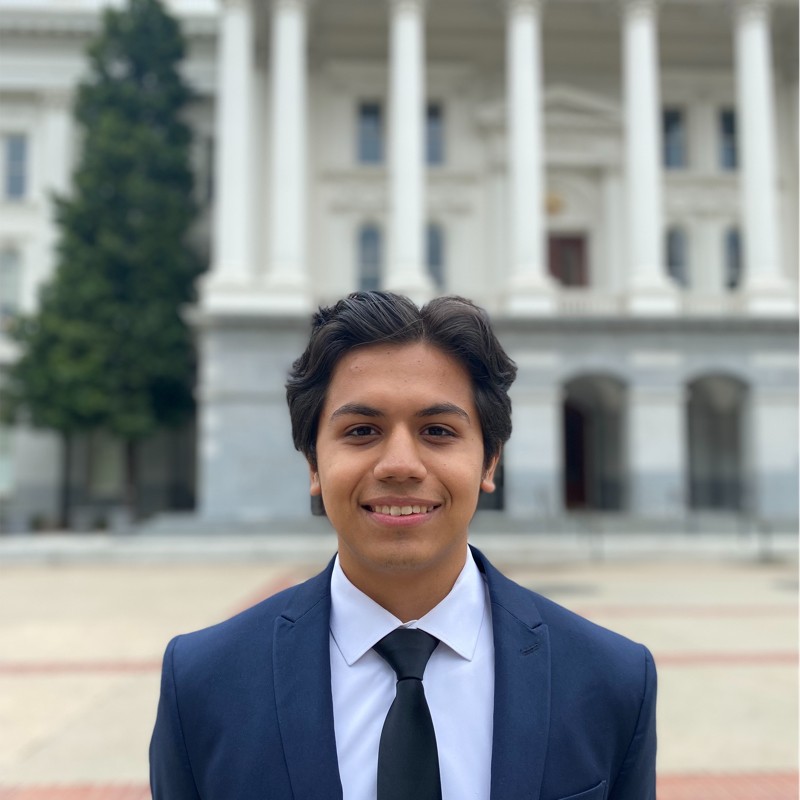 Christian Dieguez young latino UC Berkeley college student smiling and wearing a blue suit