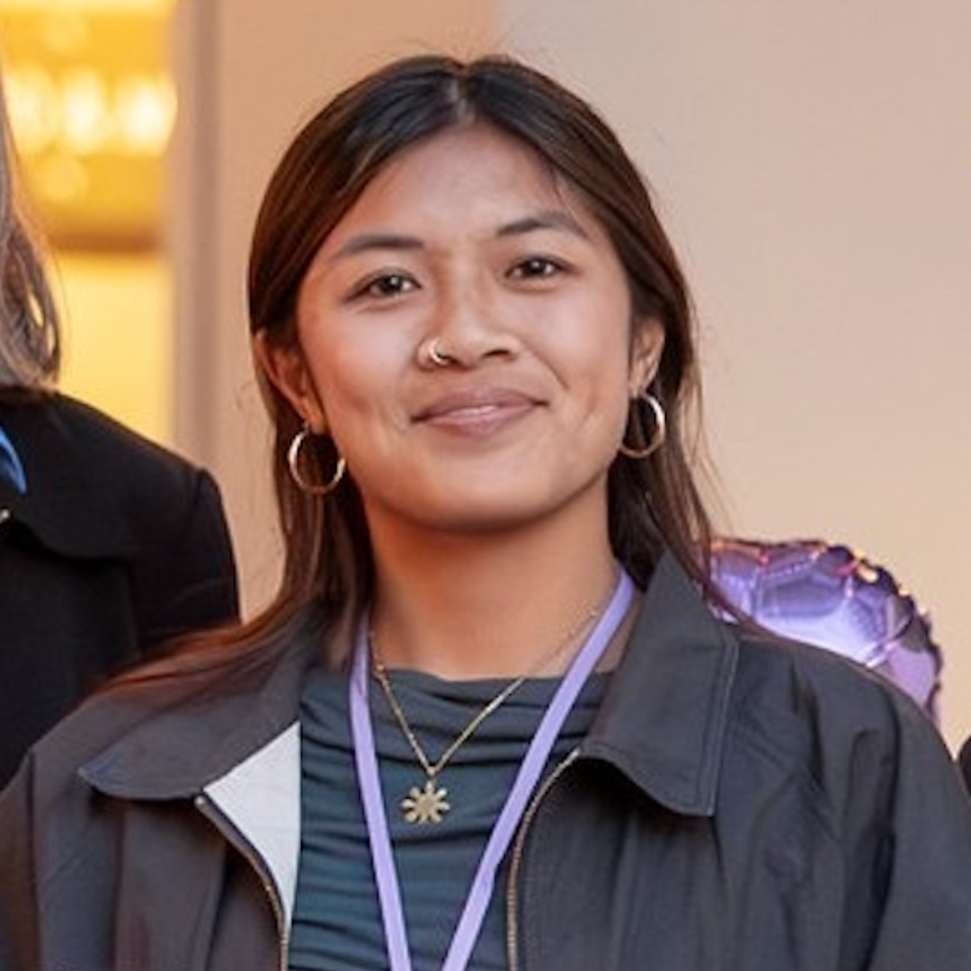 young woman in front of Berkeley library with a white button-up shirt and blazer