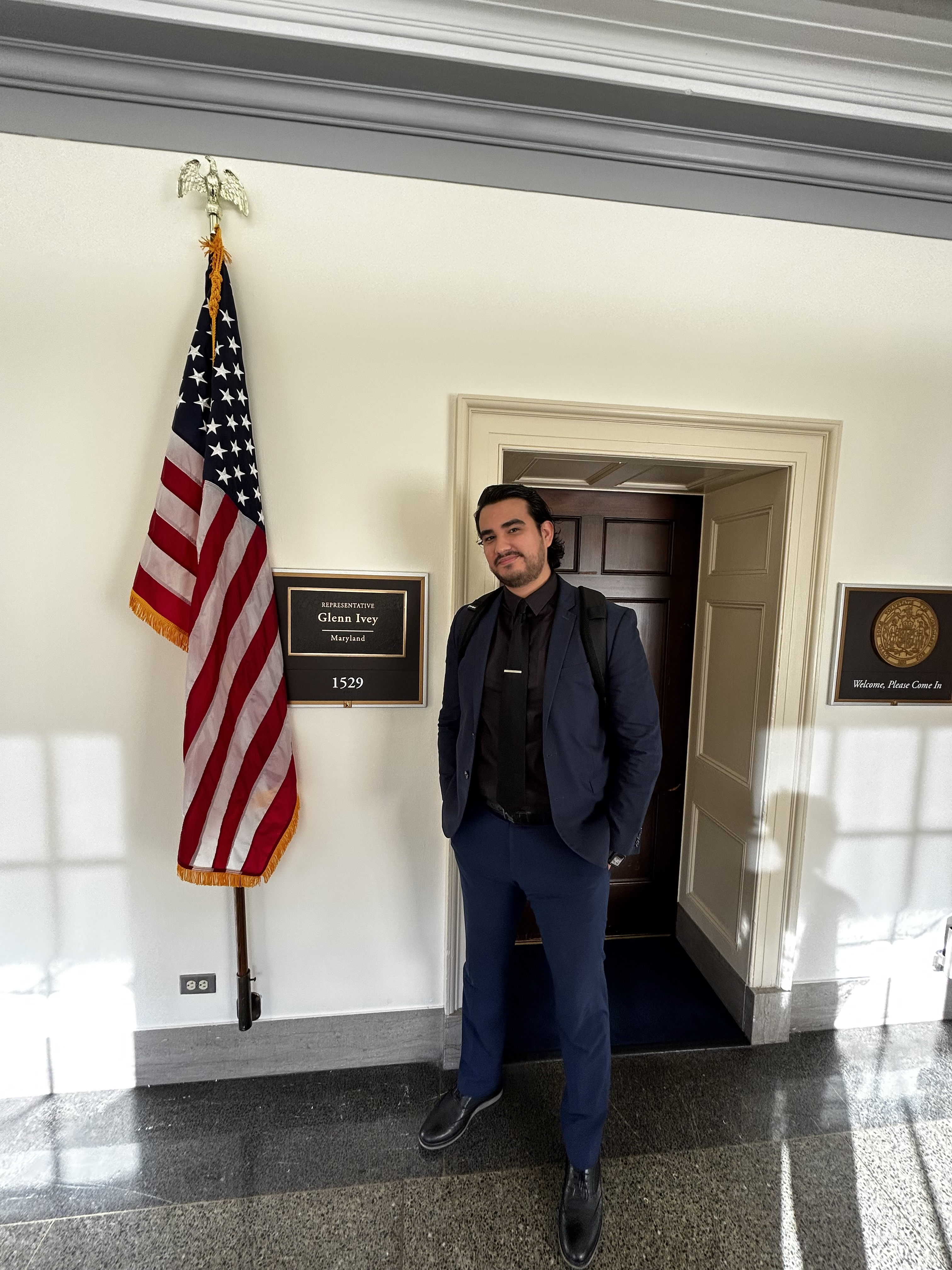 Spring 2023 UCDC Fellow Luis Leon Lopez standing outside Representative Glenn Ivey's office