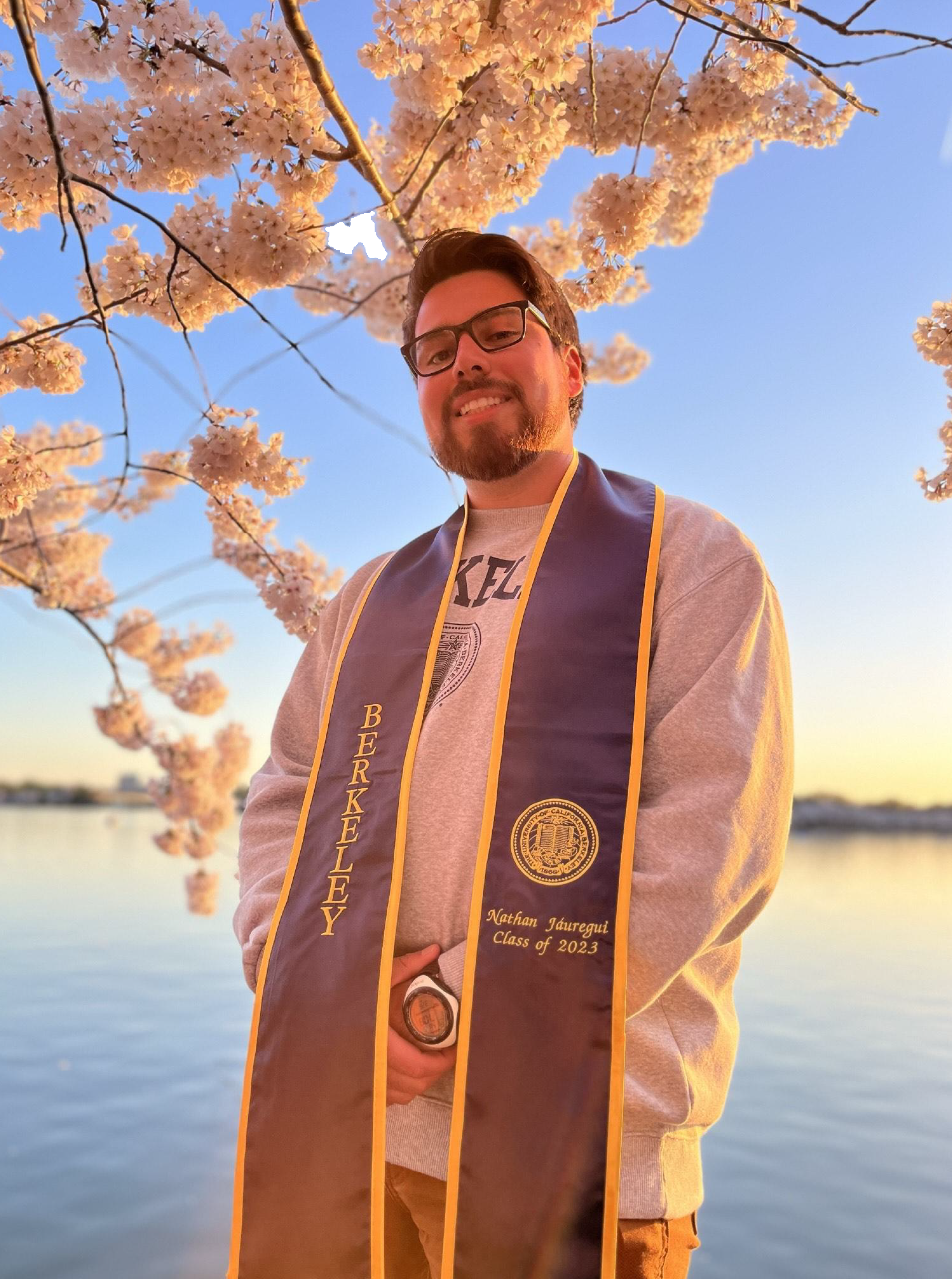 Spring 2023 UCDC Fellow Nathan Jauregui standing with his graduation stole