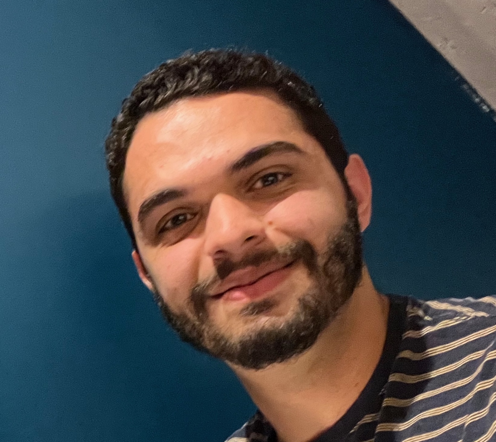 Alexander Agadjanian standing in front of blue wall