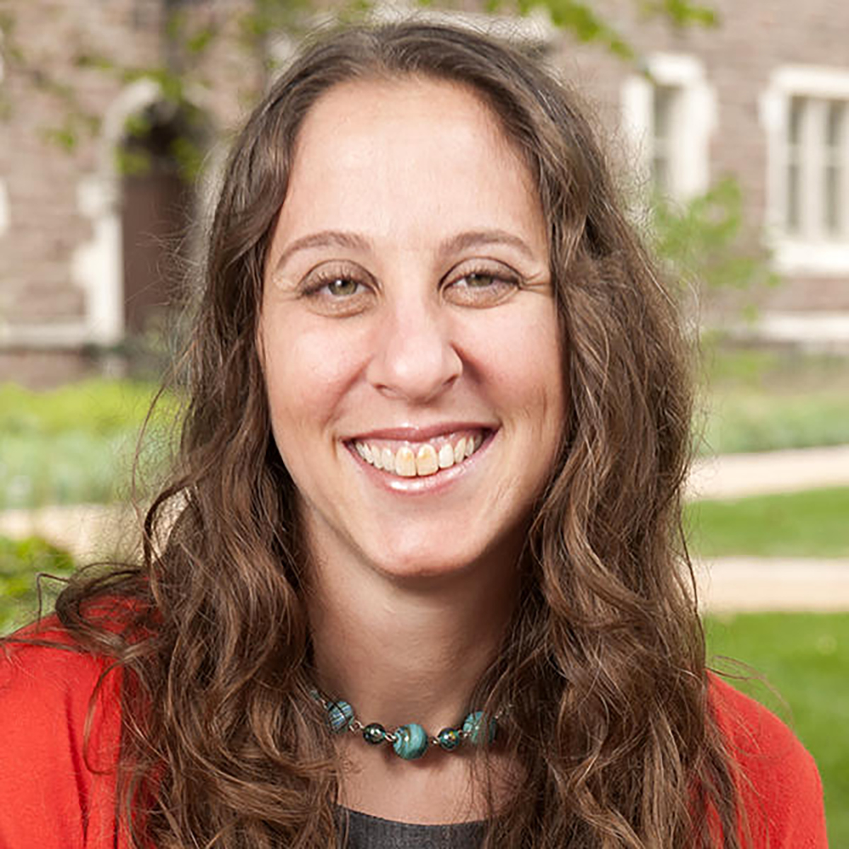 Ronit Y. Stahl Ronit Y. Stahl smiling, from the shoulders up, wearing a red top