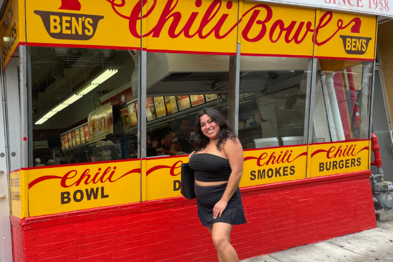 Photo of UCDC Fellow taken in front of Washington D.C. landmark restaurant "Ben's Chili Bowl"