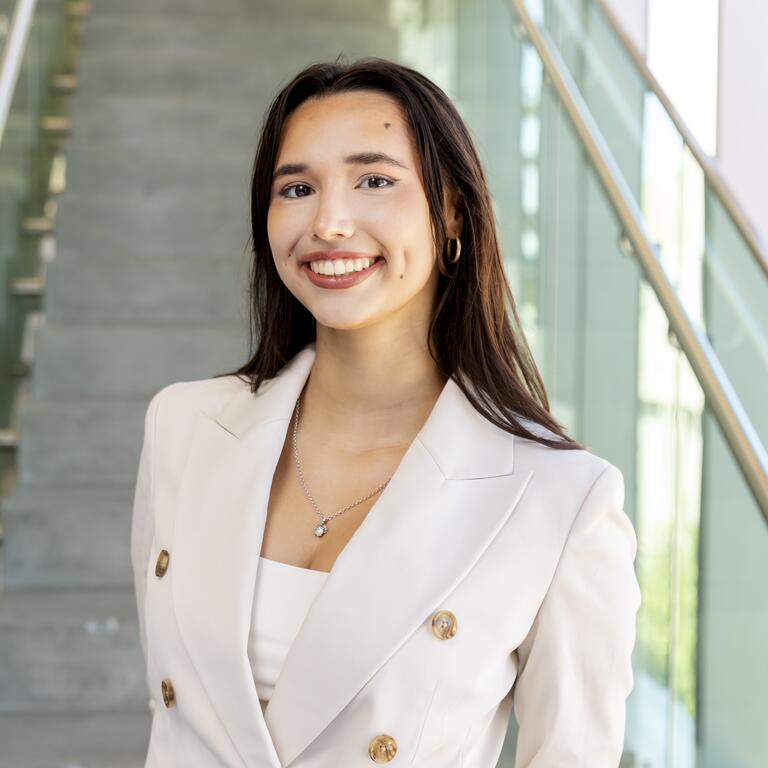 Young woman poses in professional attire