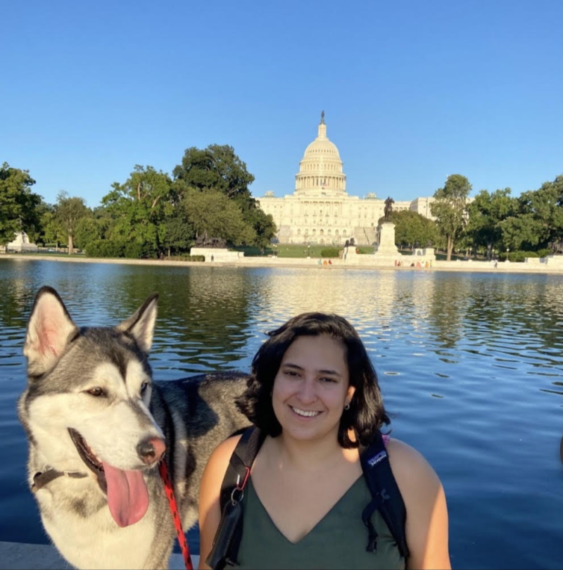 Daniela Rodas and a huskey dog in the foreground of Washington D.C. 