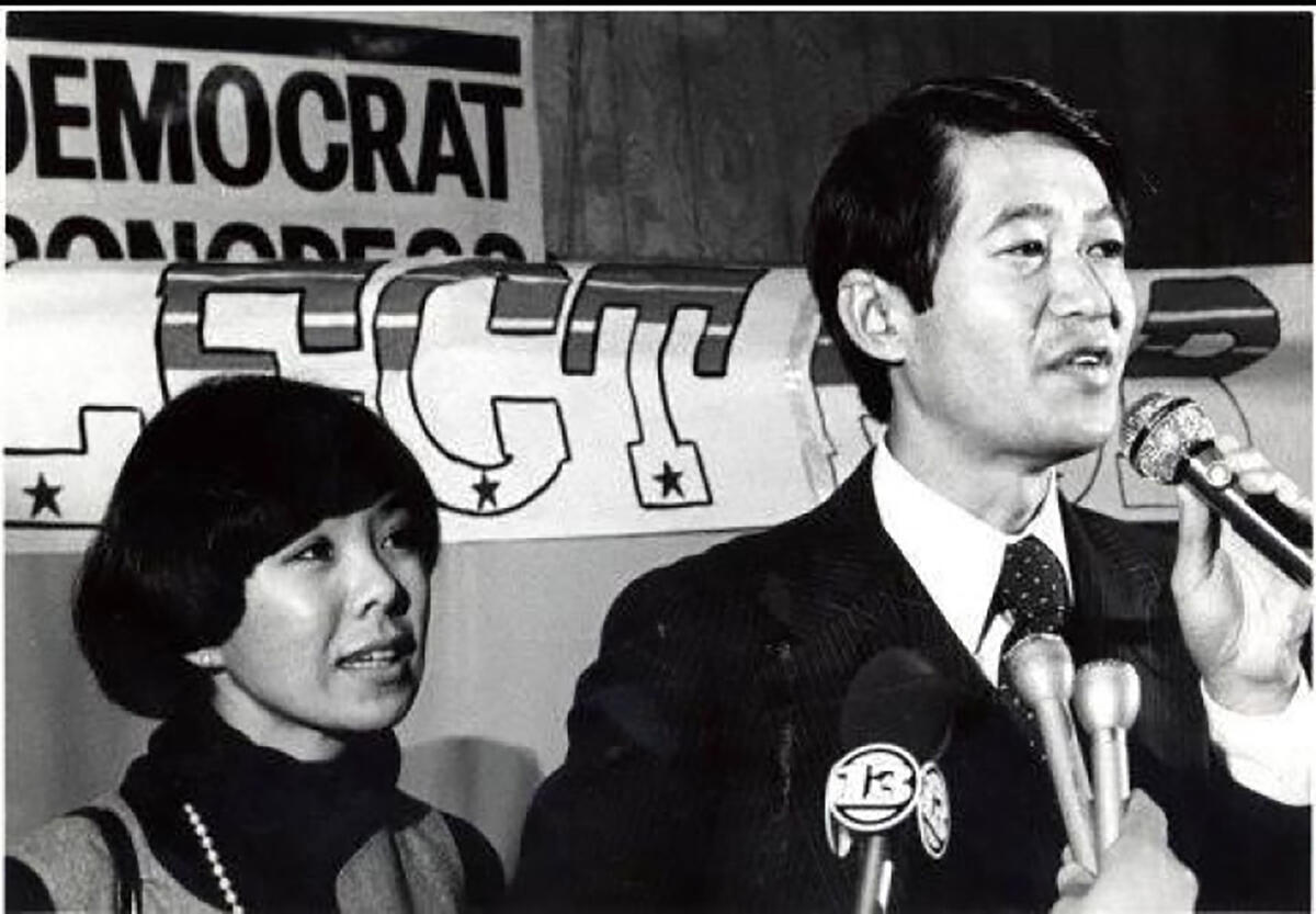 black and white photo of young Bob speaking at a podium with Doris Matsui standing beside him