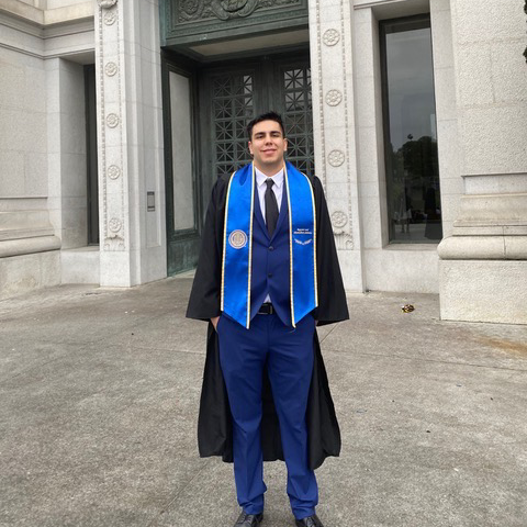 Mustafa Barraj in graduation attire standing on UC Berkeley Campus
