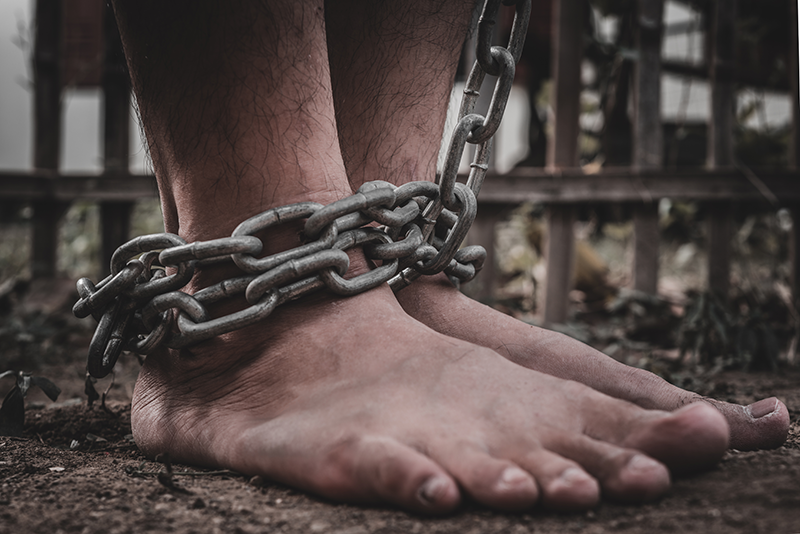picture of shackled feet with no shoes on