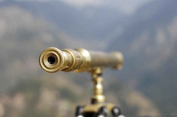 picture of a telescope in the foreground of mountains
