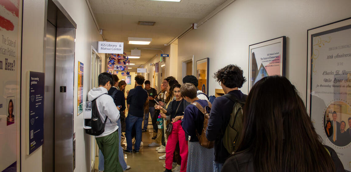 Cal students gather in the hallway of the Institute of Governmental Studies before the 2024 Presidential Debate Watch Party