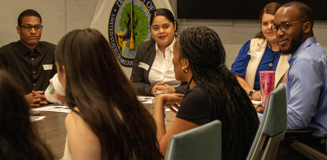 People speak at a conference table