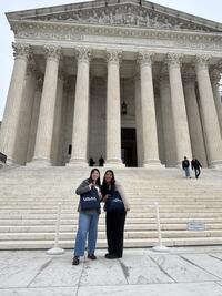 latina woman posing in front of building