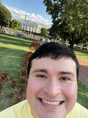 Young man poses in front of the White House